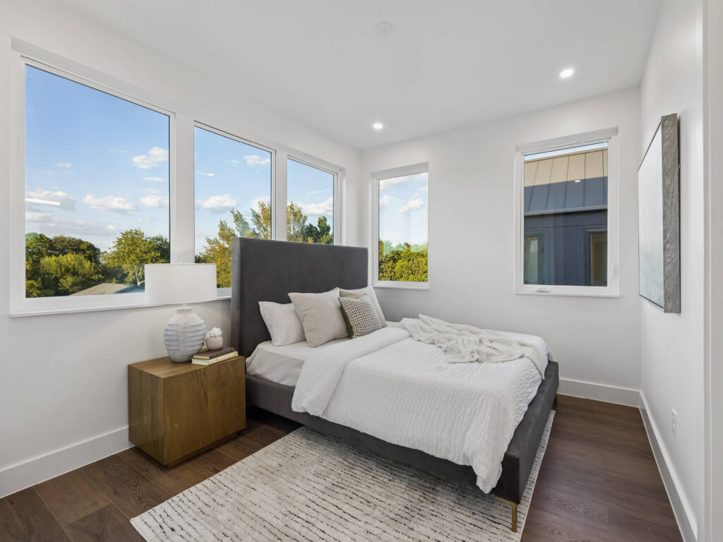 Interior view of modern townhome bedroom with large window at 4101 Menchaca Road, Austin, TX 78704