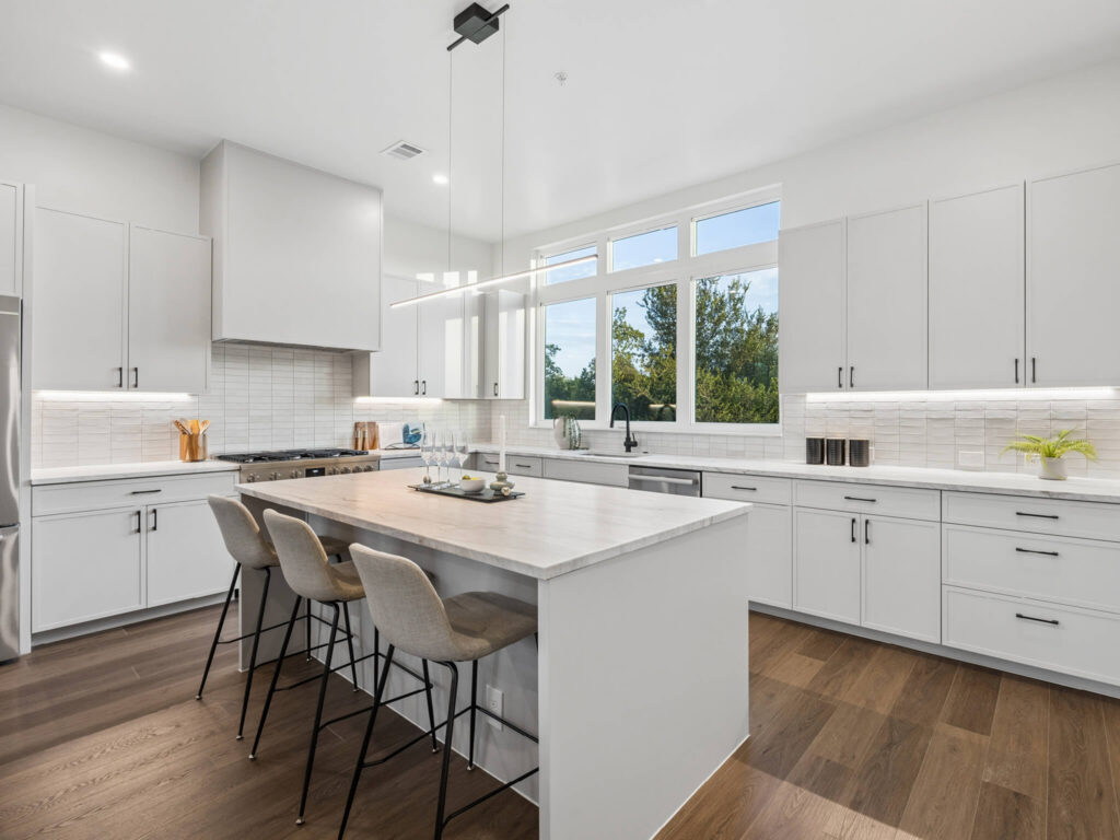 Interior view of the modern light-filled kitchen with island at 4101 Menchaca Road, Austin, TX 78704